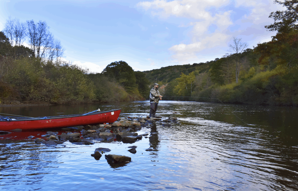 canoe on a river with a fisherman